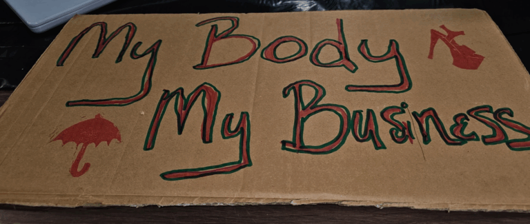 Cardboard sign that says "my body my choice."
